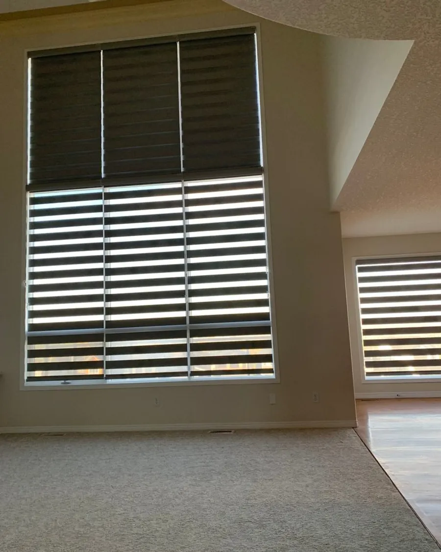 Blackout shades darkening a Calgary bedroom, edges sealed against the morning light
