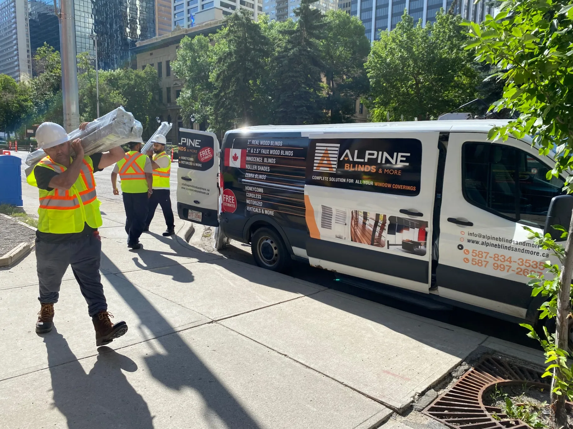 Alpine's install crew unloading custom blinds from the branded van in downtown Calgary