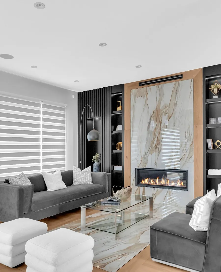 Zebra shade half raised over a large window in a Calgary living room, its sheer bands softening the daylight